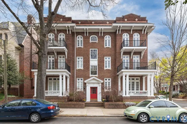 a front view of a residential apartment building with a street