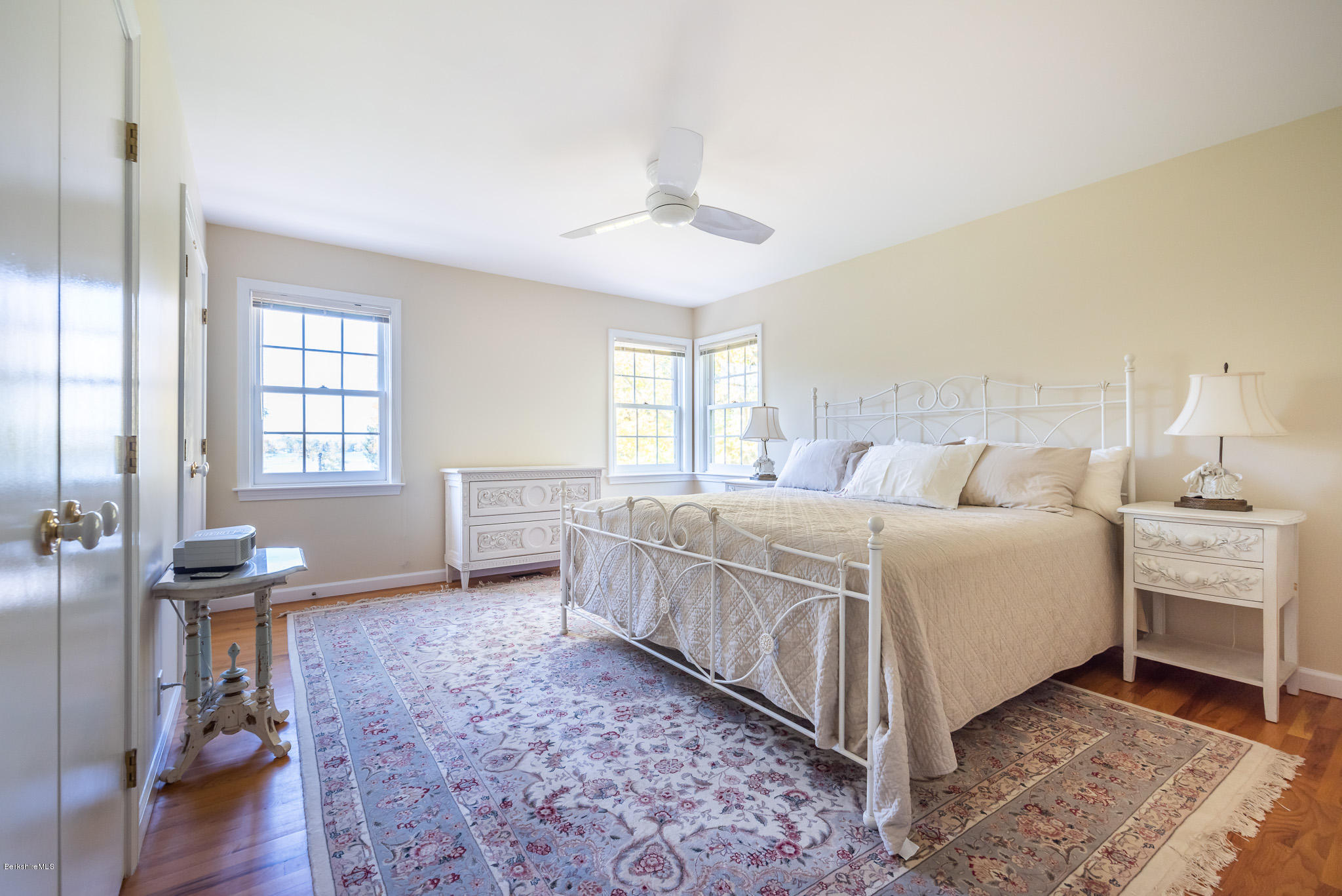 1136 Barker Road, Unit 28 Pittsfield, MA 01201 - Photo 17 of 34 a spacious bedroom with a bed and a chandelier