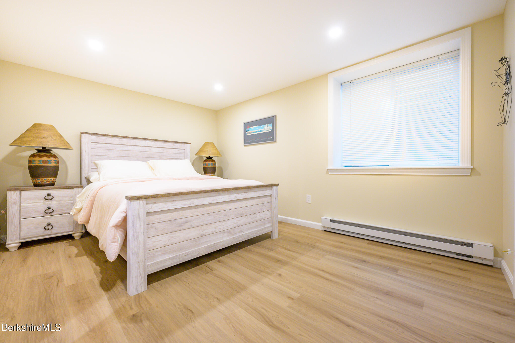 1136 Barker Road, Unit 28 Pittsfield, MA 01201 - Photo 25 of 34 a bedroom with a bed and wooden floor