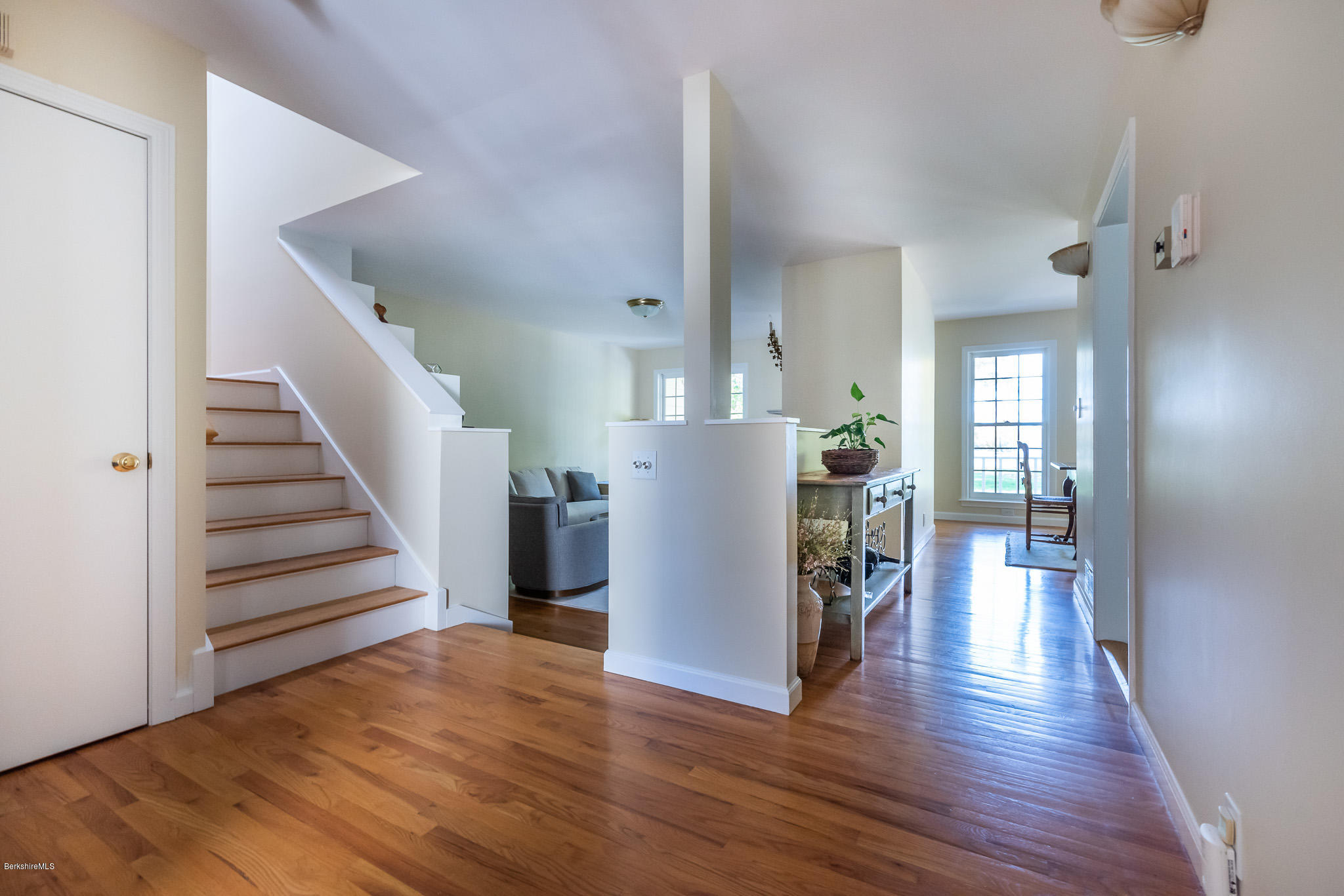 1136 Barker Road, Unit 28 Pittsfield, MA 01201 - Photo 5 of 34 a view of a hallway with wooden floor and staircase