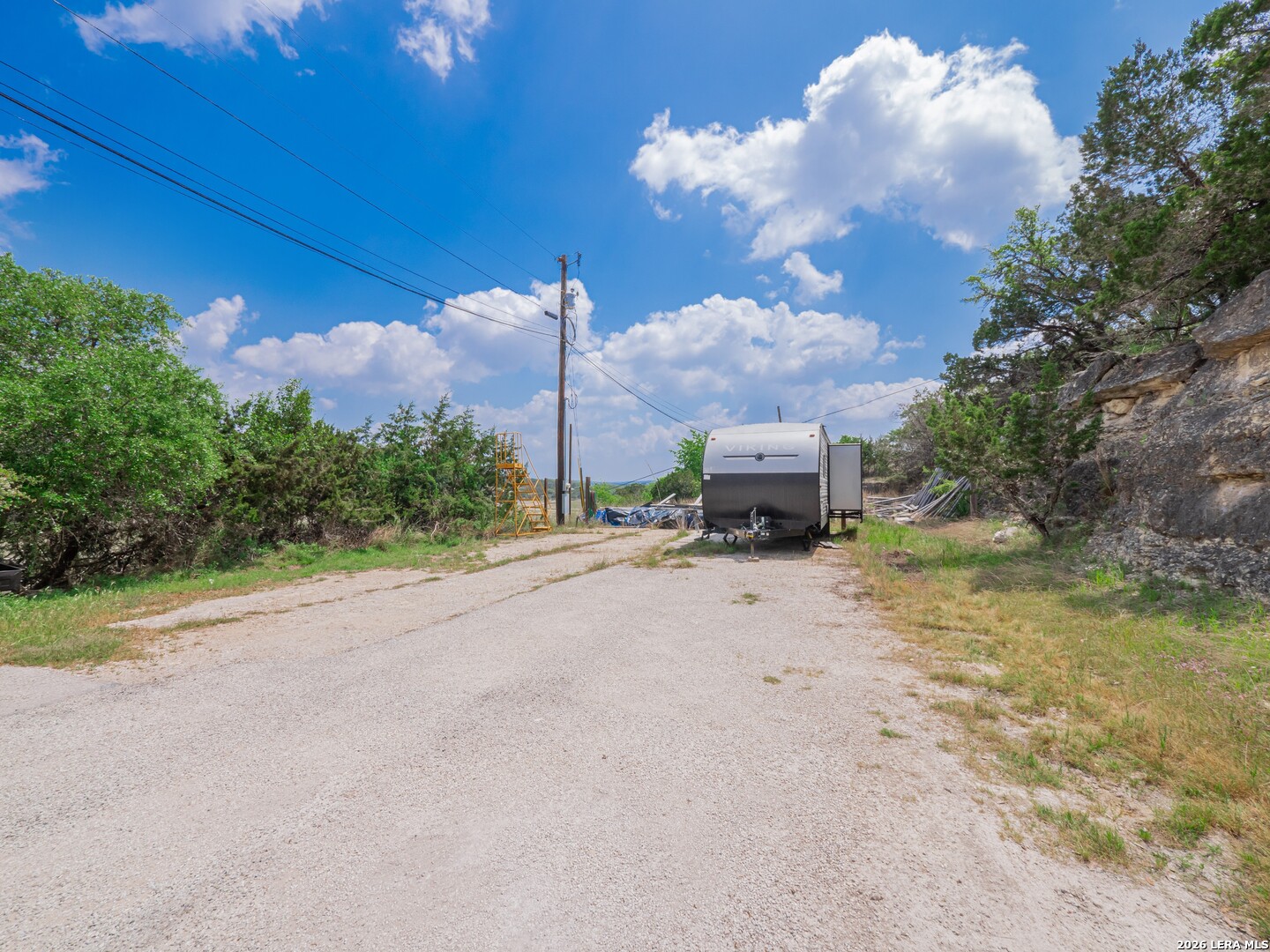 273 Plum Cove Road Lakehills, TX 78063 - Photo 5 of 10 a view of a road with a big yard