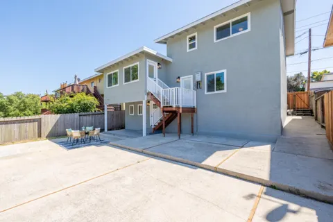 a backyard of a house with table and chairs