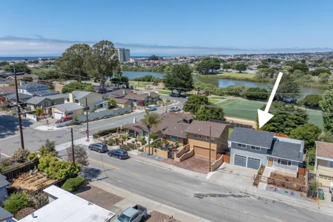 an aerial view of a house with a big yard