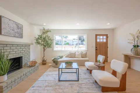 a living room with furniture a window and a fireplace