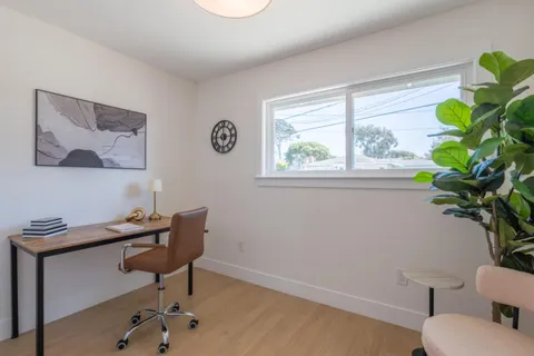 a view of a workspace with furniture and a potted plant