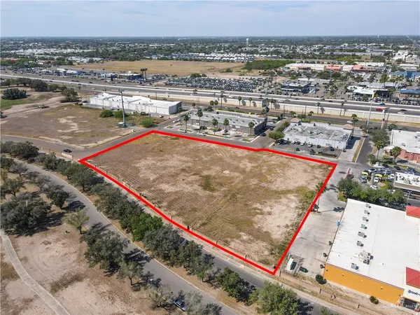 an aerial view of a tennis ground and a large park