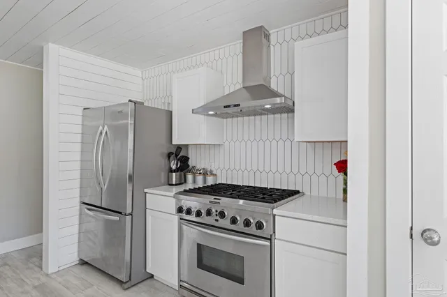 a kitchen with a stove and a refrigerator