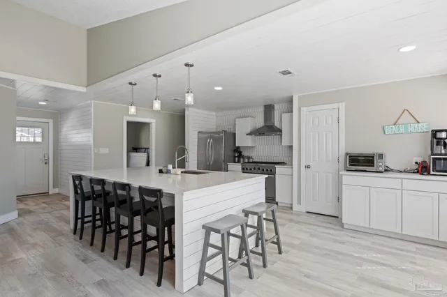 a large kitchen with a table and chairs