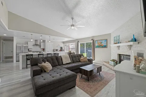a living room with furniture a fireplace and a table