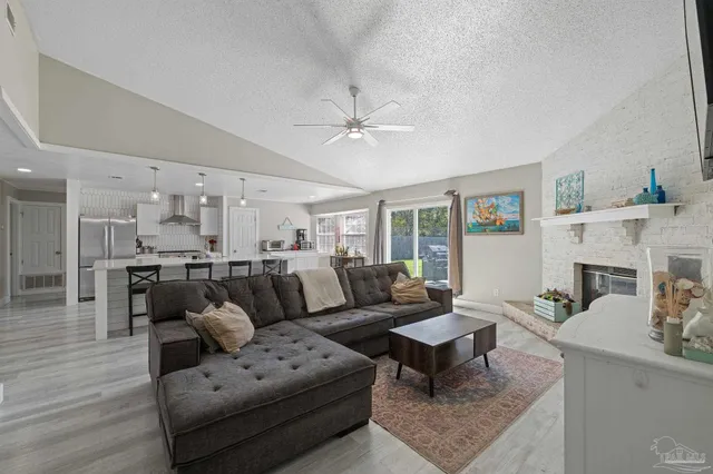a living room with furniture a fireplace and a table