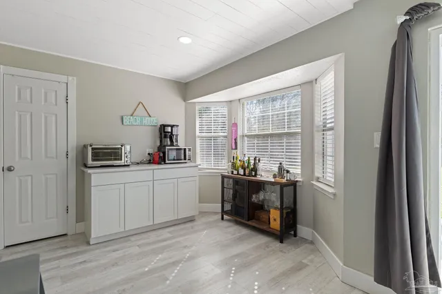 a kitchen with cabinets and wooden floor