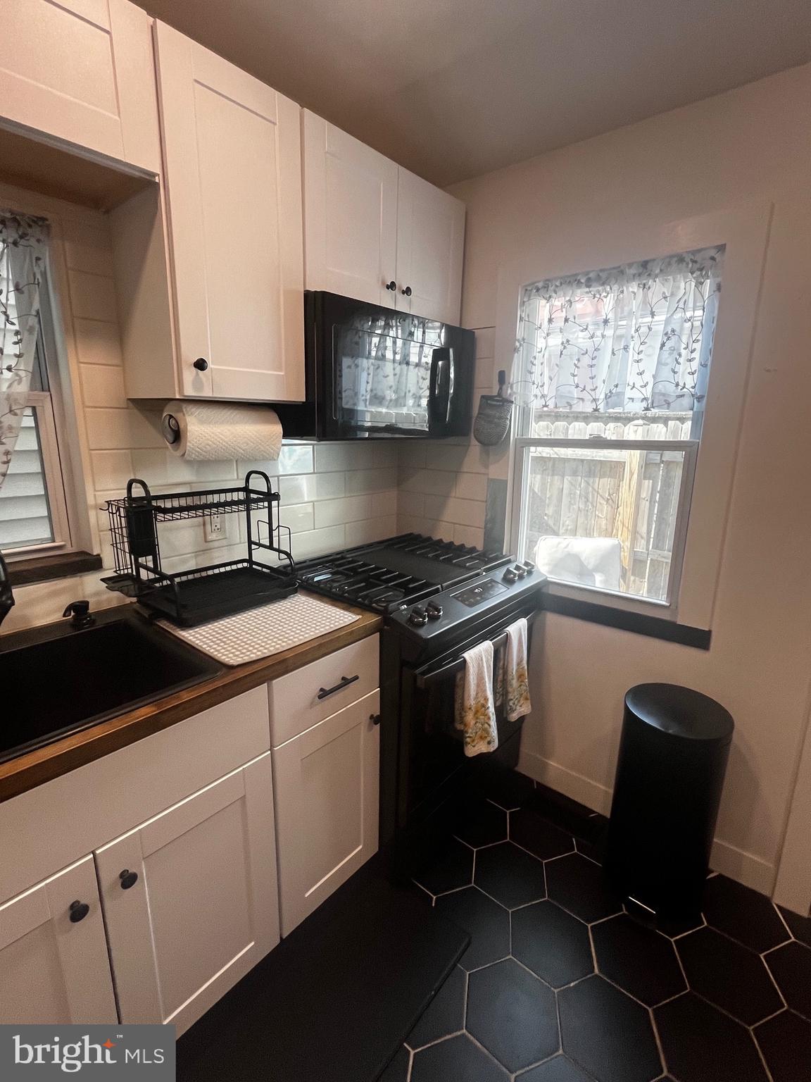 121 Mercy Street Philadelphia, PA 19148 - Photo 26 of 61 a kitchen with a sink appliances and cabinets