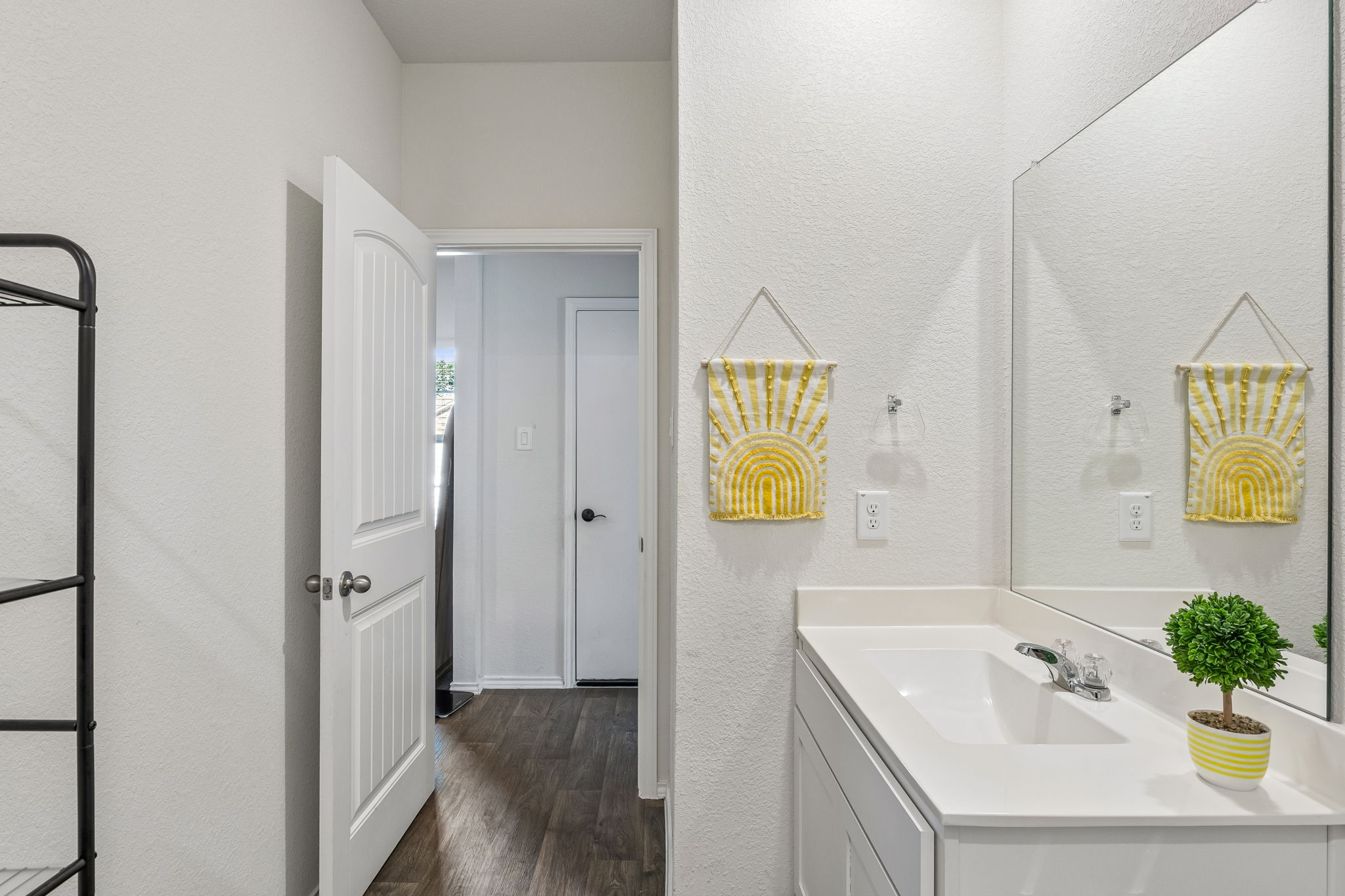 343 Sickle Loop Kyle, TX 78640 - Photo 6 of 40 Bathroom vanity with a white countertop and integrated sink, chrome faucet, and a large wall-mounted mirror
