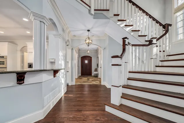 a view of entryway and hall with wooden floor