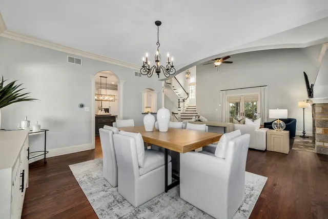 a kitchen with granite countertop a sink cabinets and wooden floor