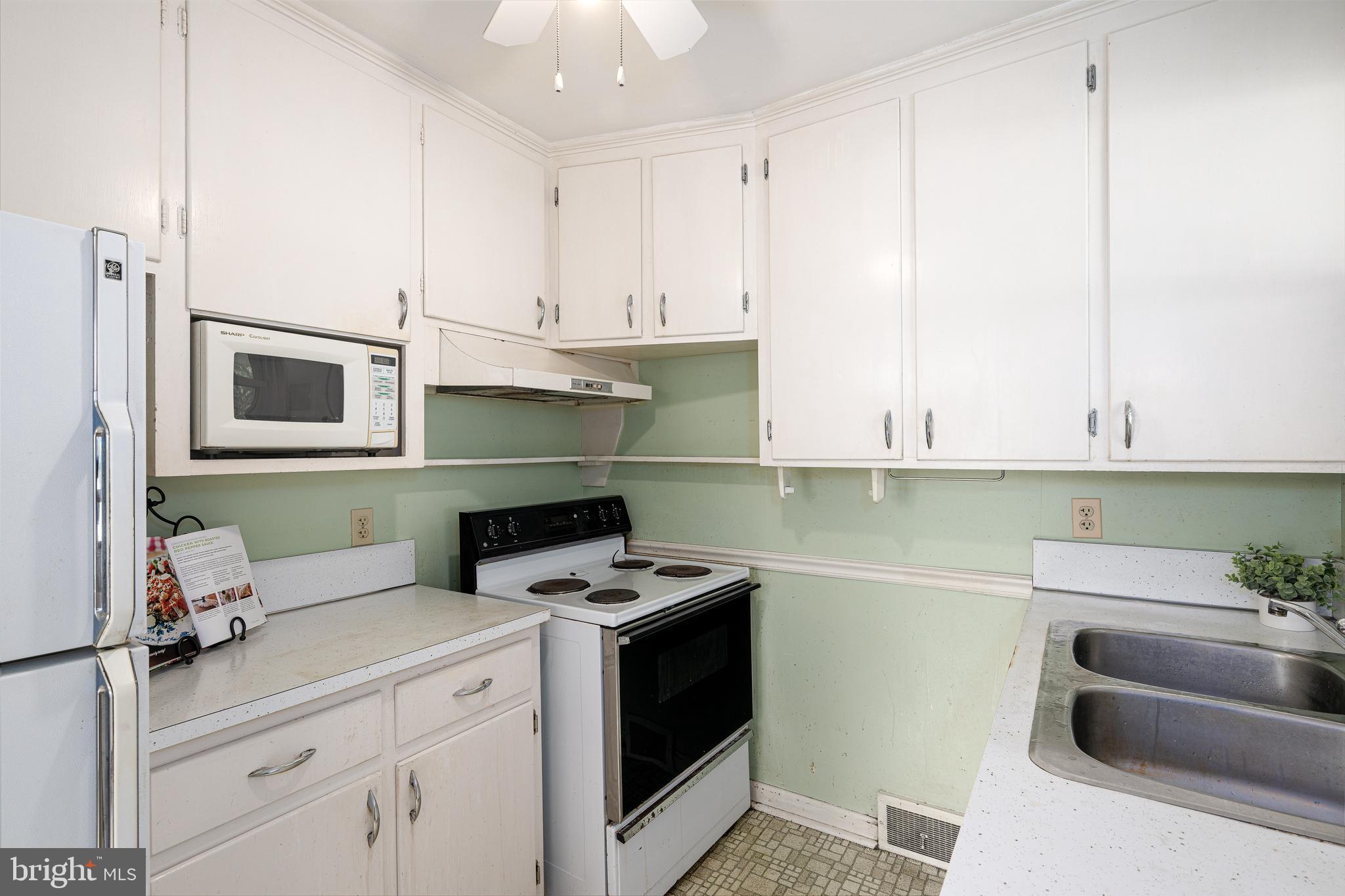 2 Norva Avenue Frederick, MD 21701 - Photo 10 of 36 a kitchen with granite countertop a sink a stove and cabinets