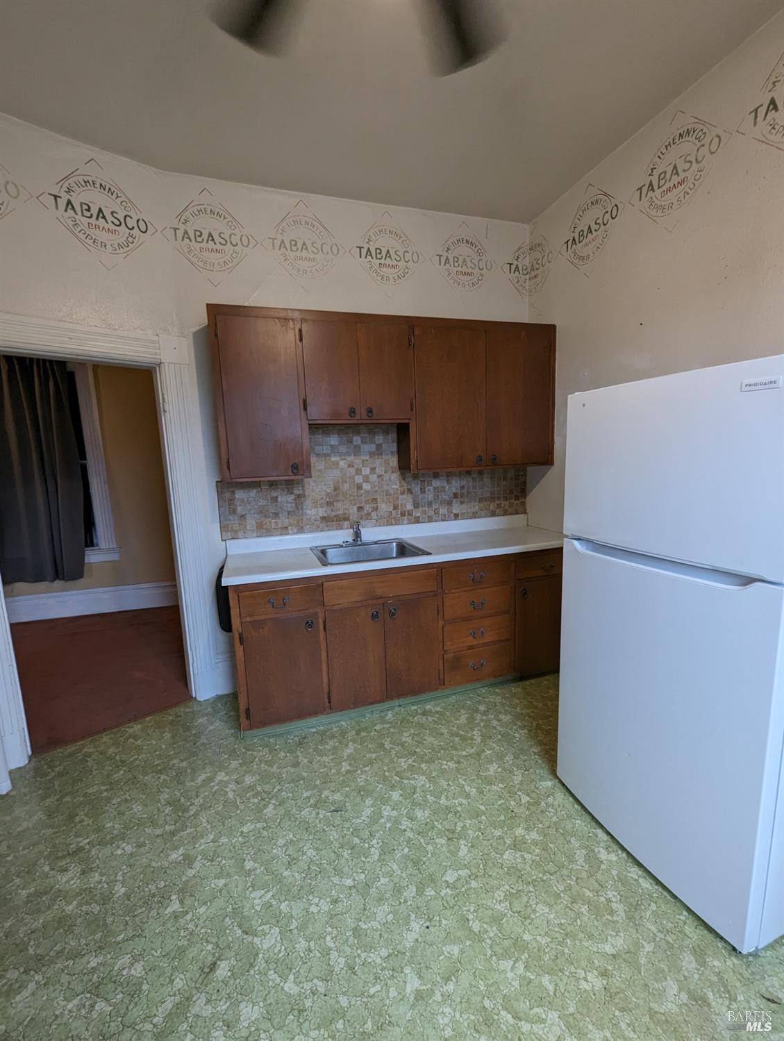 1547 4th Street, Unit A San Rafael, CA 94901 - Photo 52 of 64 a kitchen with kitchen island a counter top a refrigerator and a stove