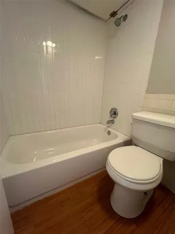 a bathroom with a toilet and a bathtub
