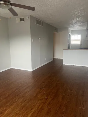 a view of wooden floor and windows in a room