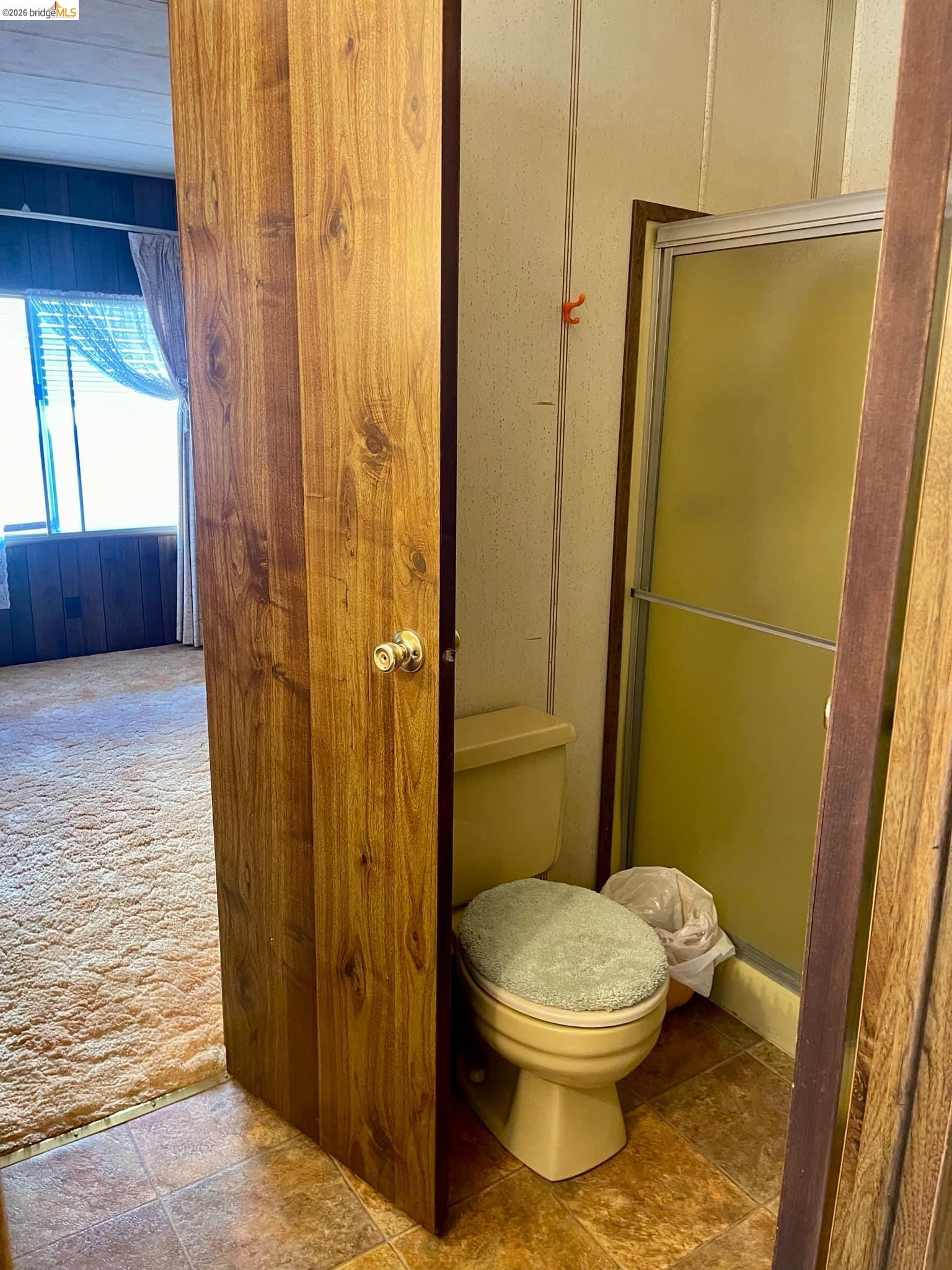 19361 Cherokee Road Tuolumne, CA 95379 - Photo 16 of 41 a bathroom with a toilet and shower