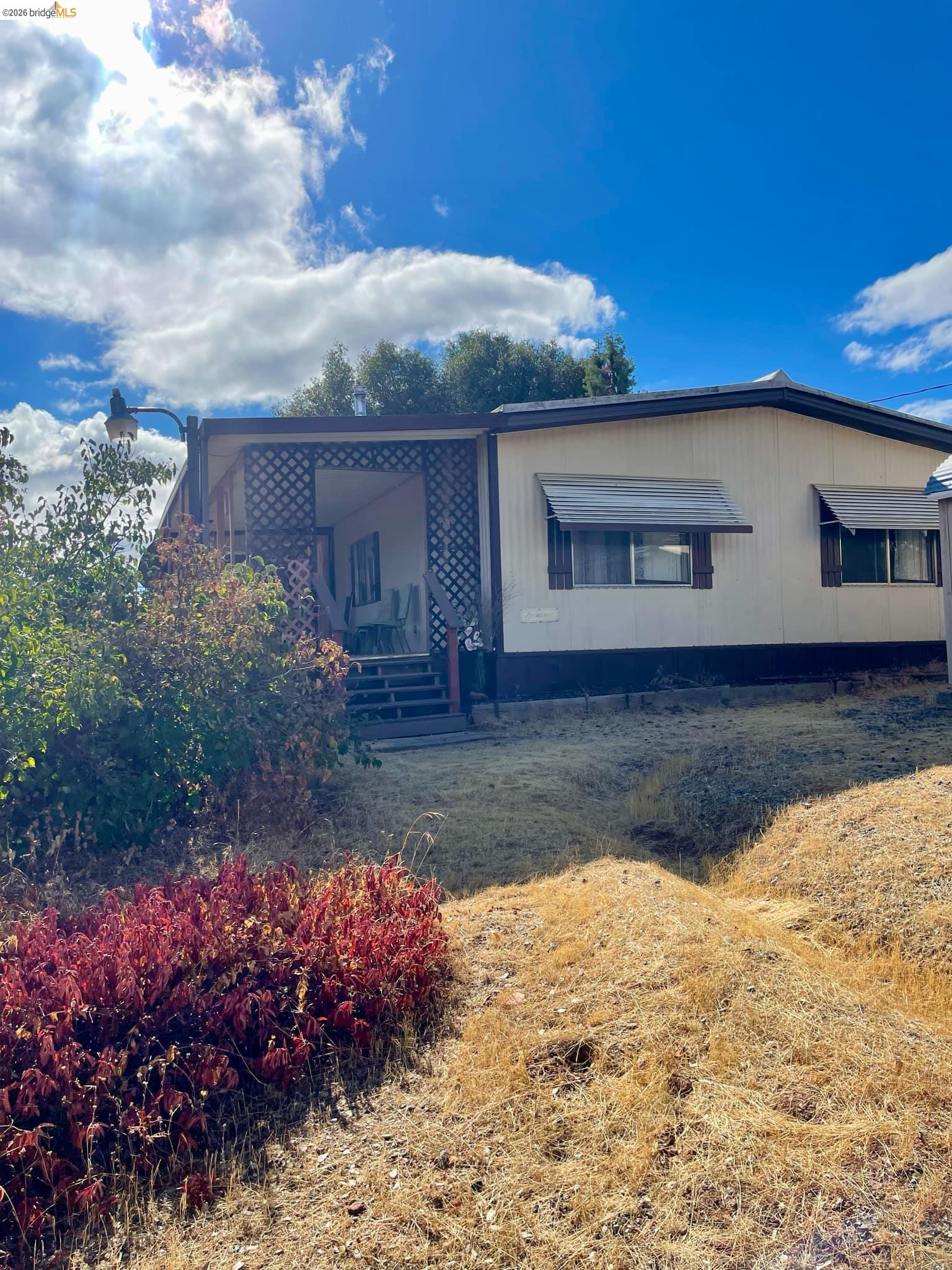 19361 Cherokee Road Tuolumne, CA 95379 - Photo 20 of 41 a front view of house with yard and trees in the background