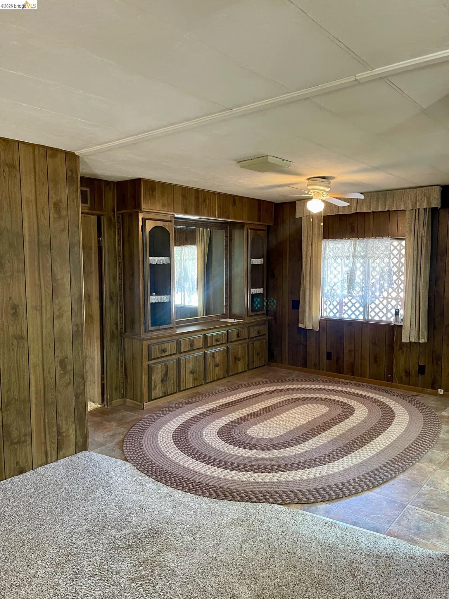 19361 Cherokee Road Tuolumne, CA 95379 - Photo 6 of 41 a living room with furniture a large window and a flat screen tv