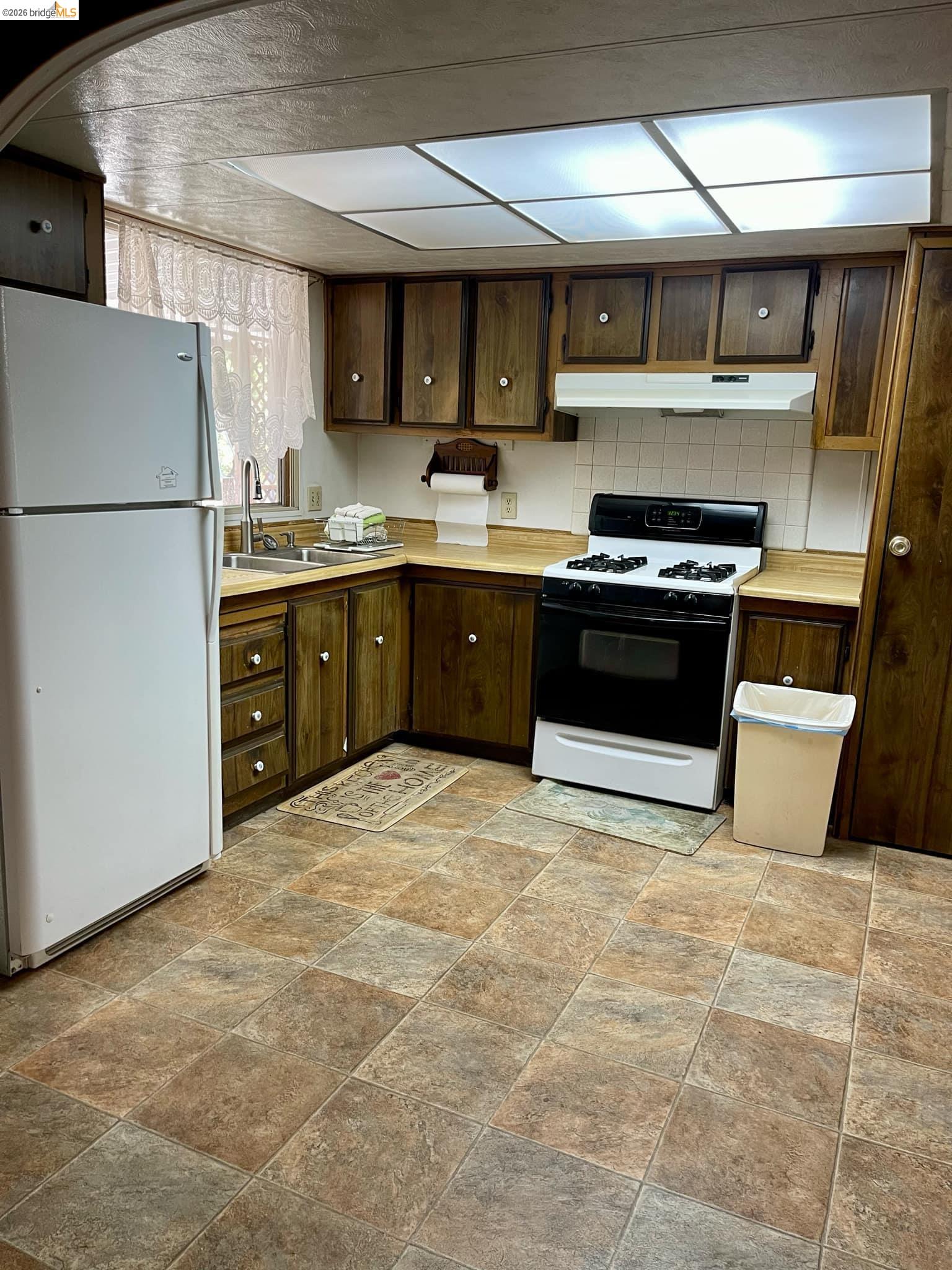 19361 Cherokee Road Tuolumne, CA 95379 - Photo 9 of 41 a kitchen with stainless steel appliances granite countertop a stove a sink dishwasher a refrigerator and a microwave