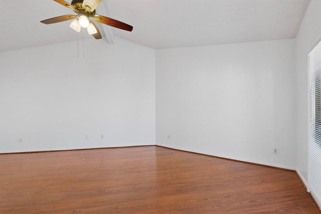 8545 Midpark Road, Unit 16 Dallas, TX 75240 - Photo 2 of 29 Unfurnished room featuring beamed ceiling, dark wood-type flooring, and ceiling fan