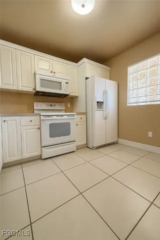 a kitchen with cabinets and steel appliances