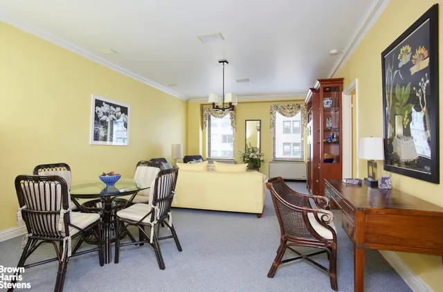 a dining room with furniture and window