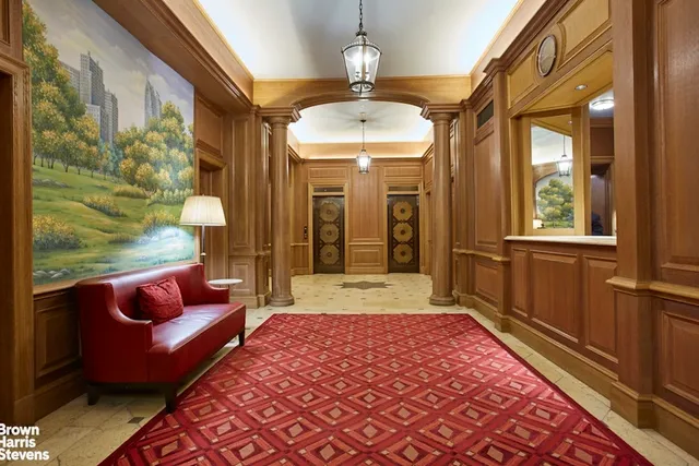 a hallway with furniture and a chandelier