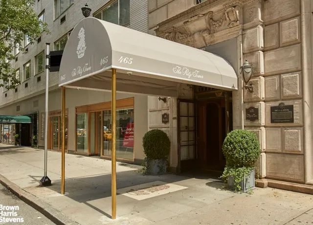 a lobby with furniture and a large mirror