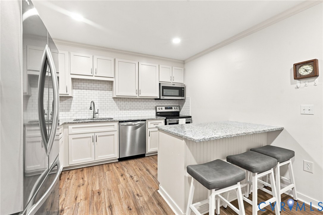 8398 Rowanty Road Carson, VA 23830 - Photo 8 of 30 Kitchen featuring wood-finish flooring, white cabi