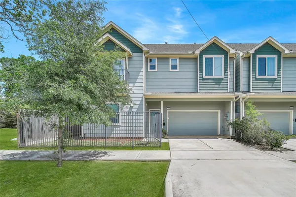 a front view of a house with a garden and yard