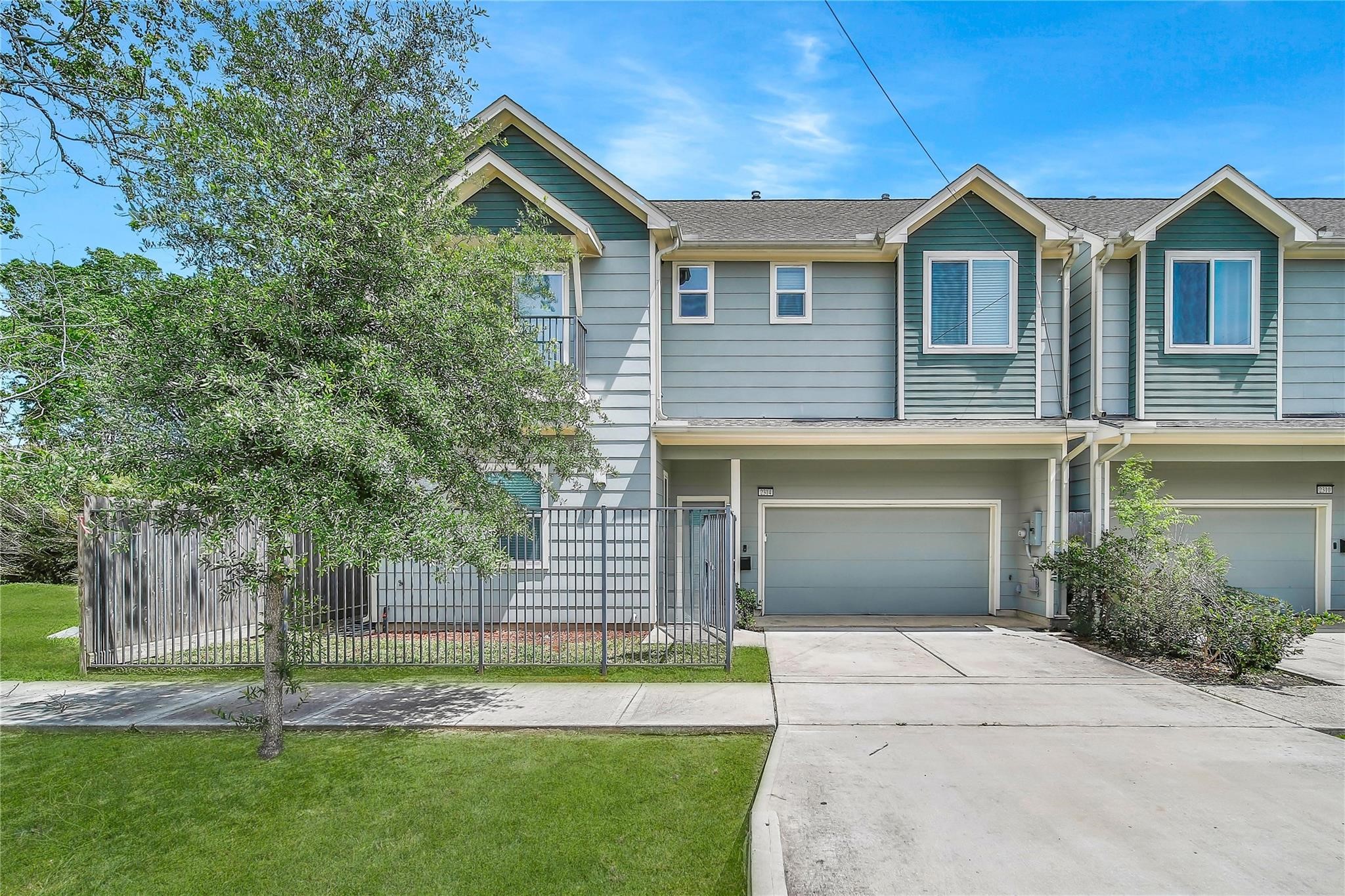 a front view of a house with a garden and yard