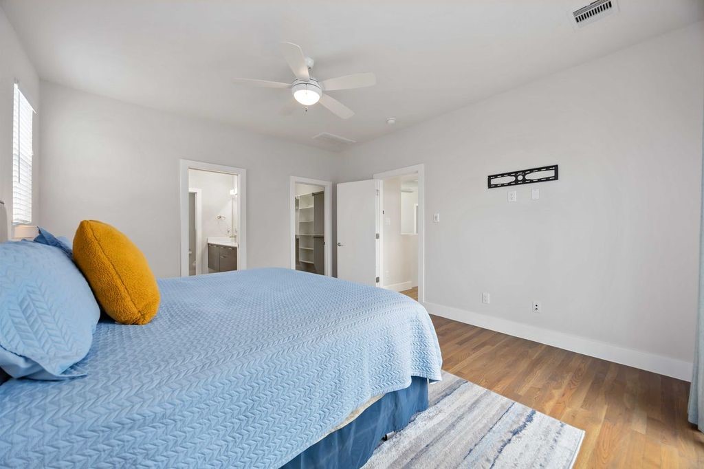 2314 Gagne Street Houston, TX 77020 - Photo 13 of 28 a bedroom with a bed and wooden floor