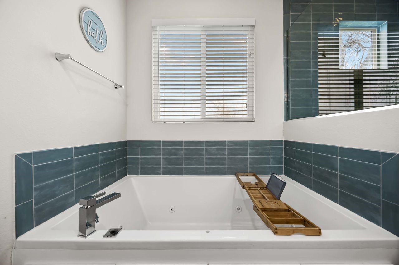 2314 Gagne Street Houston, TX 77020 - Photo 17 of 28 a bathroom with a bathtub a window and a shower