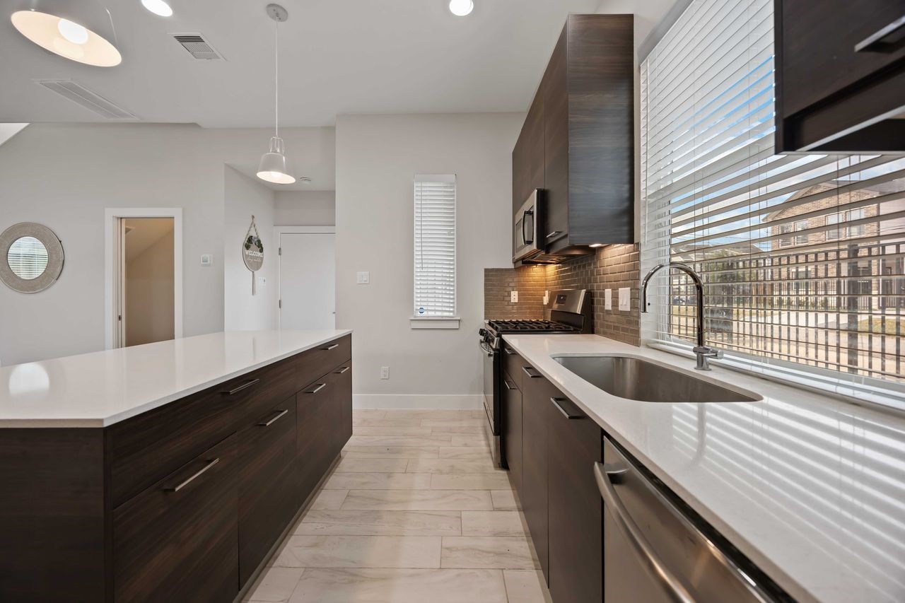 2314 Gagne Street Houston, TX 77020 - Photo 2 of 28 a kitchen with granite countertop a sink and a stove