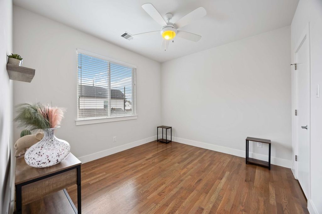 2314 Gagne Street Houston, TX 77020 - Photo 22 of 28 a view of an empty room with window and wooden floor