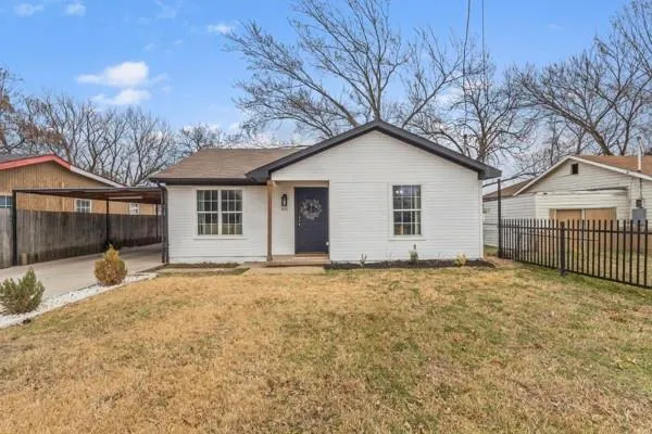 a view of a house with a yard and garage
