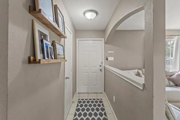 a hallway with front door wooden floor and staircase