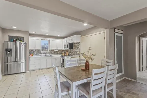 a kitchen with stainless steel appliances granite countertop a refrigerator and a stove top oven