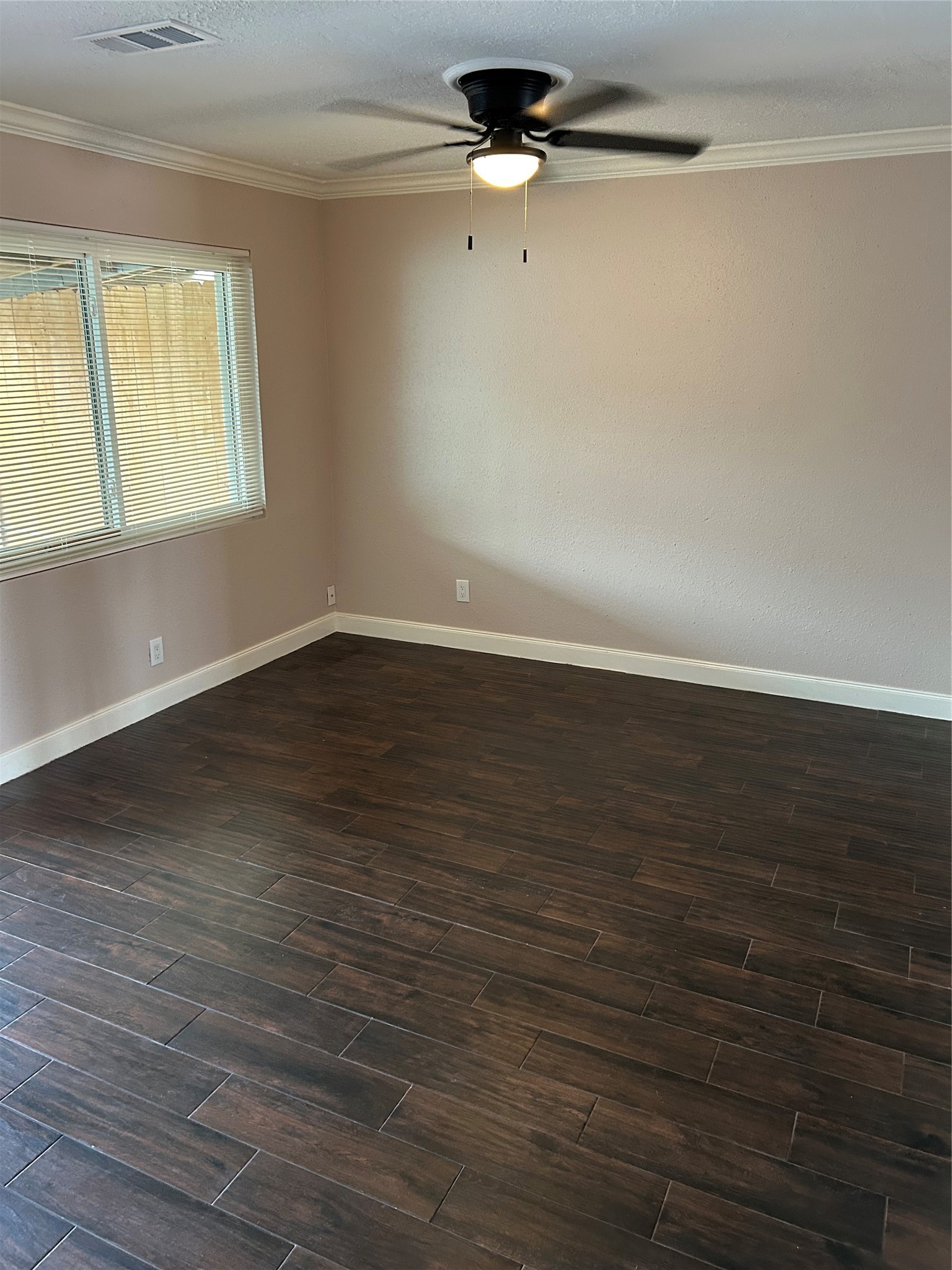 20333 Fieldtree Drive Humble, TX 77338 - Photo 2 of 23 an empty room with wooden floor fan and windows