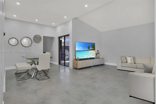 a living room with furniture and a chair