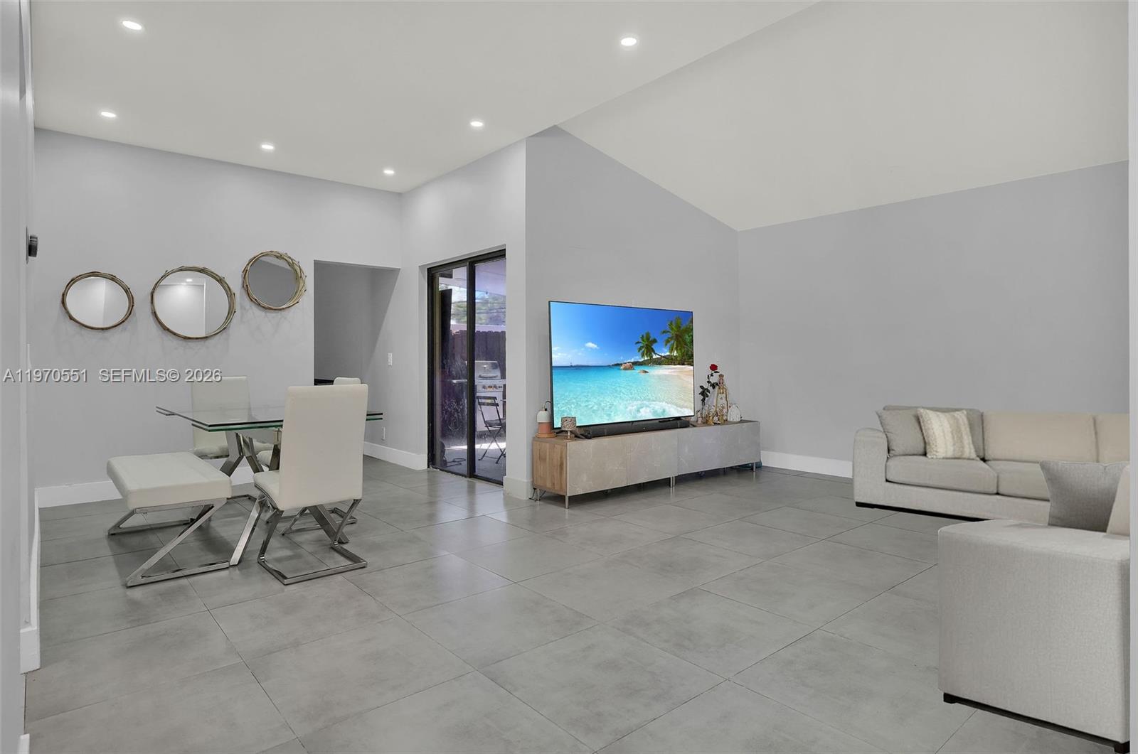 17032 Northwest 63rd Place Hialeah, FL 33015 - Photo 1 of 13 a living room with furniture and a chair