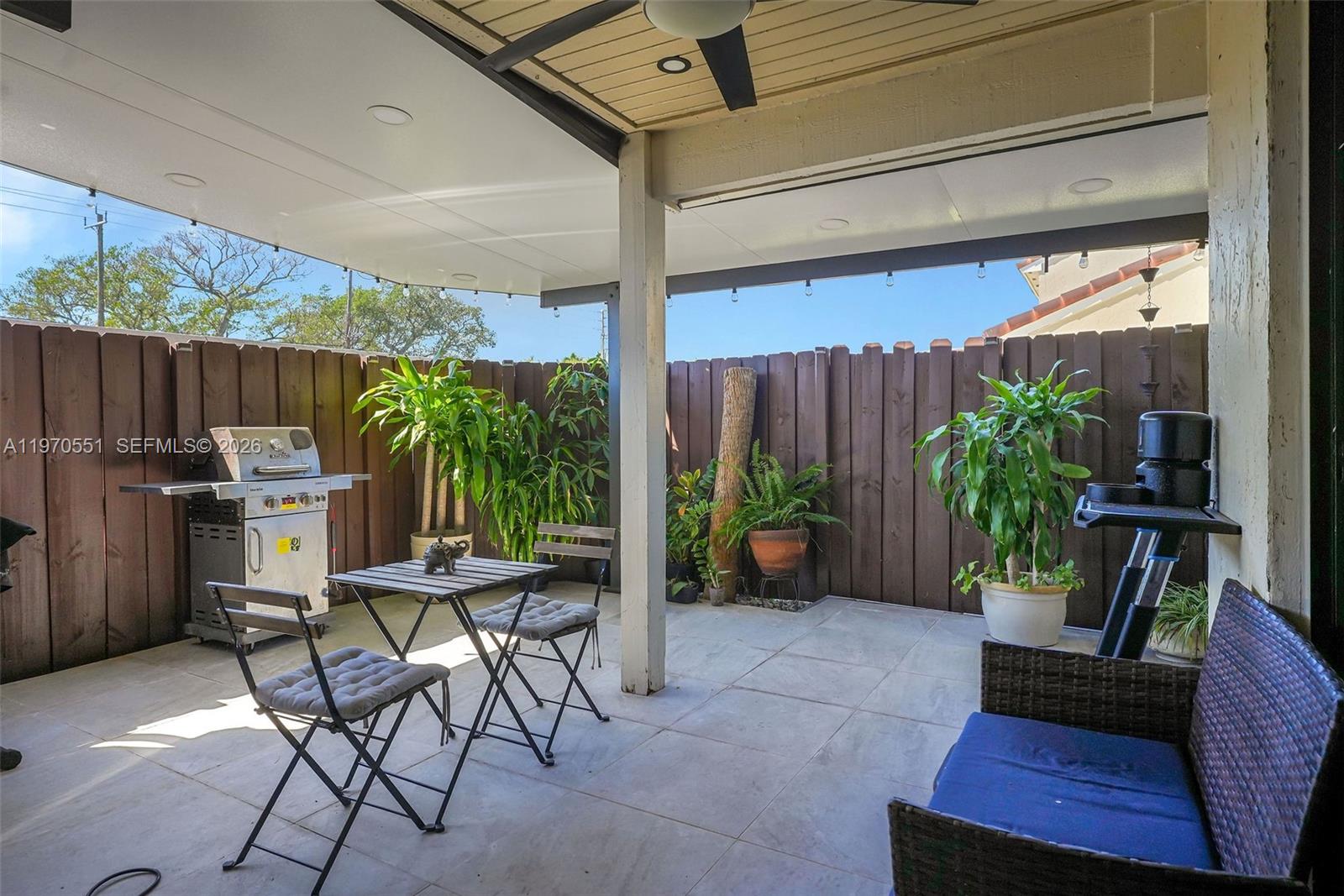 17032 Northwest 63rd Place Hialeah, FL 33015 - Photo 12 of 13 a view of a backyard with furniture and a potted plant