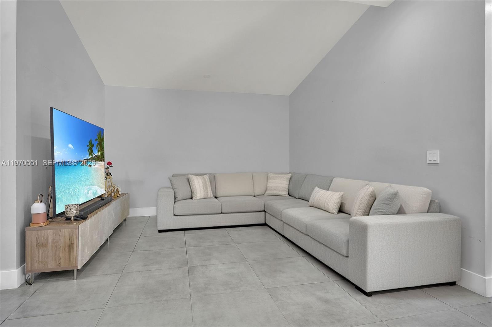 17032 Northwest 63rd Place Hialeah, FL 33015 - Photo 2 of 13 a living room with furniture and a flat screen tv