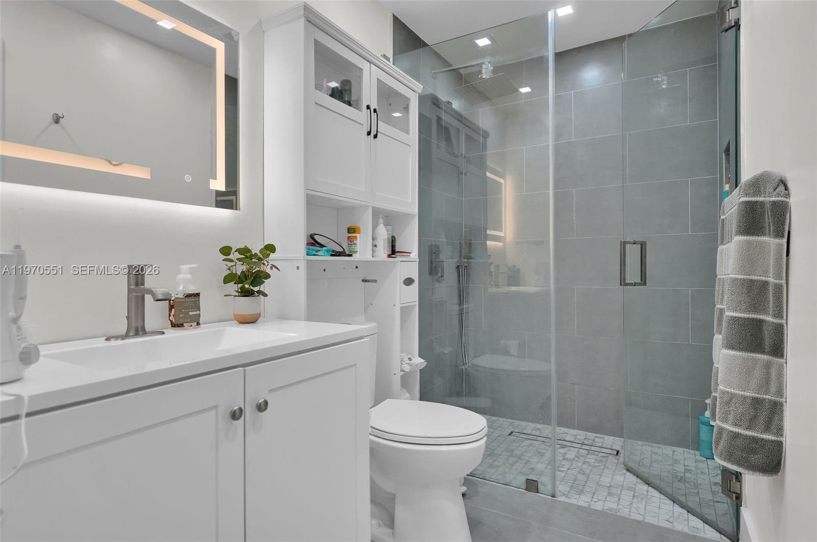 17032 Northwest 63rd Place Hialeah, FL 33015 - Photo 8 of 13 a bathroom with a sink toilet and shower