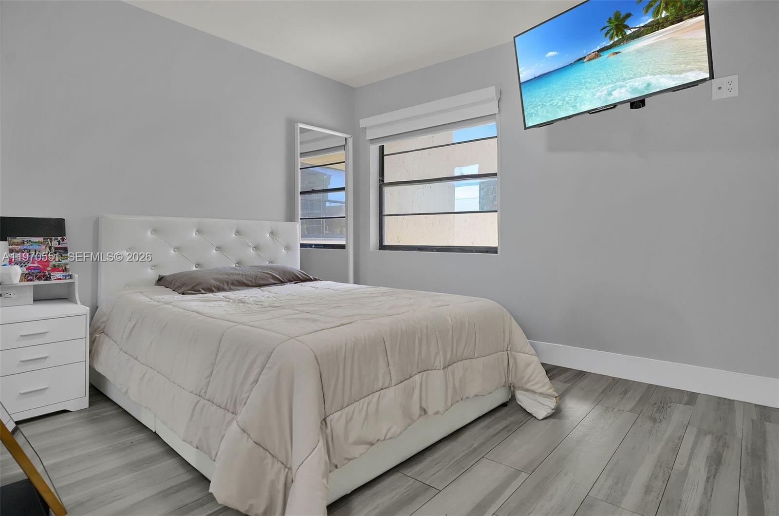 17032 Northwest 63rd Place Hialeah, FL 33015 - Photo 9 of 13 a bedroom with a bed and a window