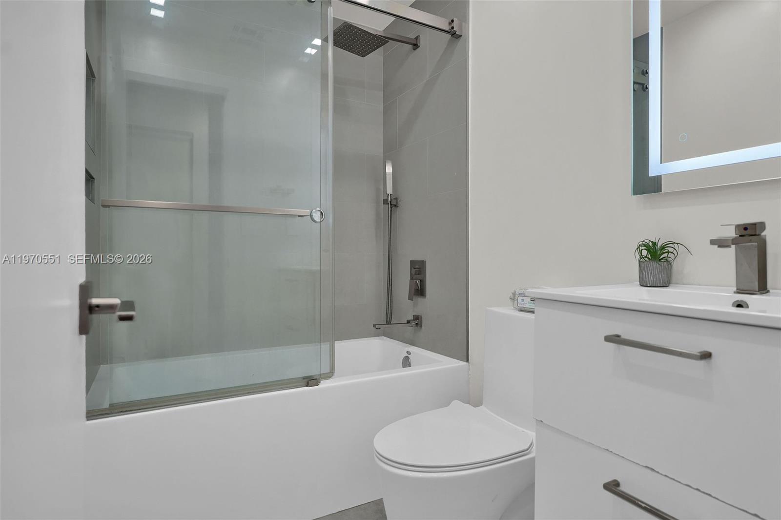 17032 Northwest 63rd Place Hialeah, FL 33015 - Photo 10 of 13 a bathroom with a toilet and a shower